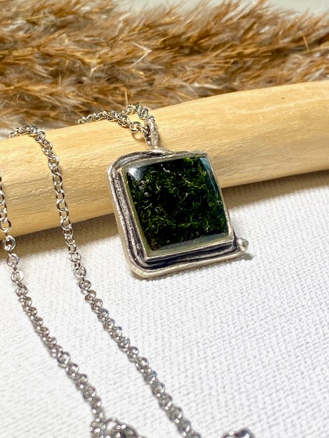 Silver-plated square pendant filled with dark green real moss.