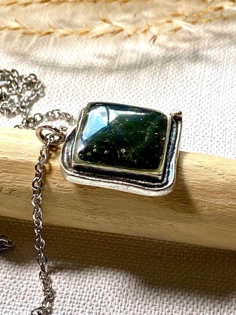 Silver-plated square pendant filled with dark green real moss.