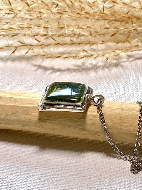 Silver-plated square pendant filled with dark green real moss.