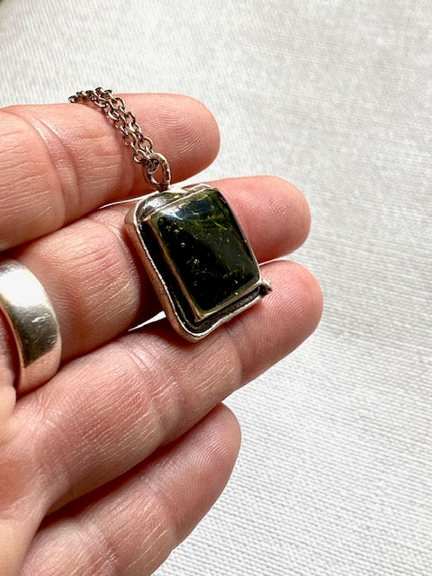 Silver-plated square pendant filled with dark green real moss.