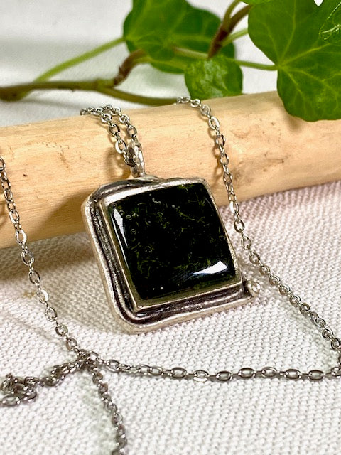 Silver-plated square pendant filled with dark green real moss.