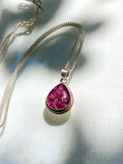 Exclusive silver drop pendant with pink flowers.