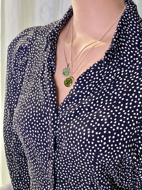 Beautiful silver-plated round pendant with moss.