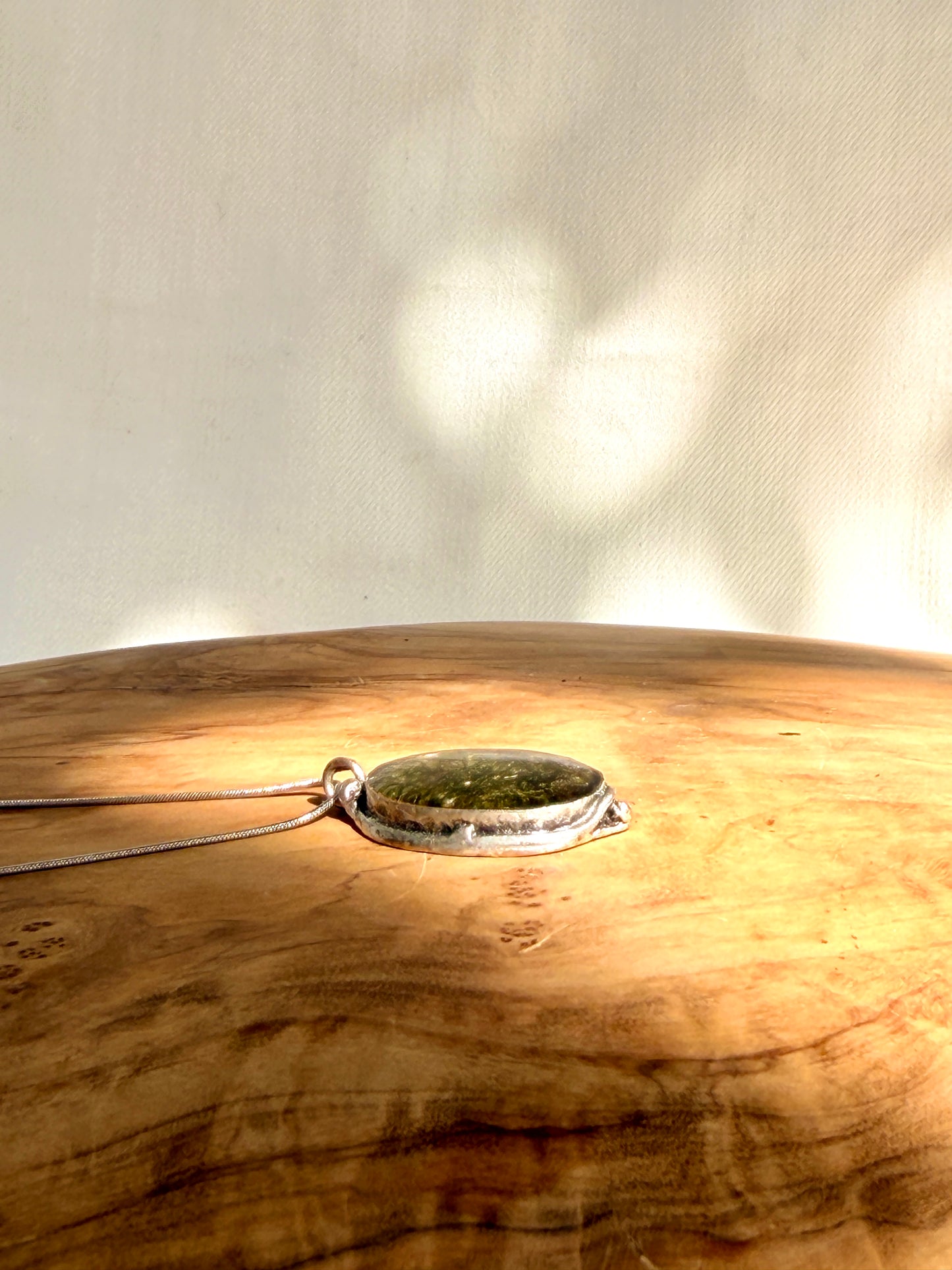 Silver-plated oval pendant (brass) with green moss.