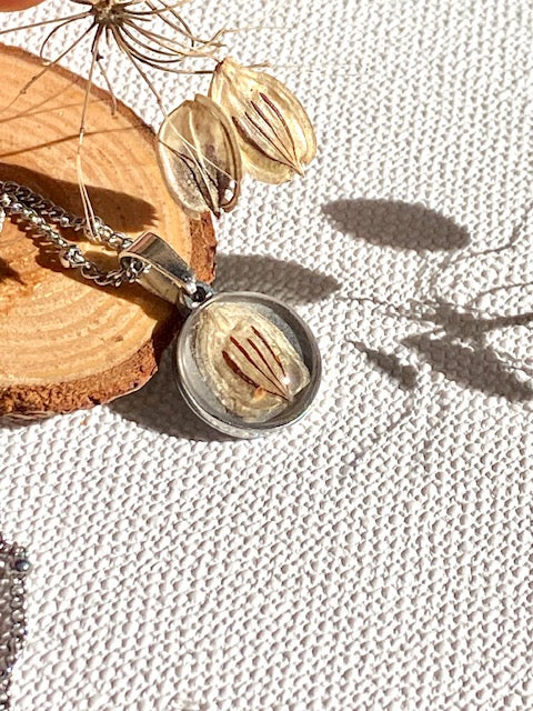 Nature pendant with beige/brown seed of a Hogweed.