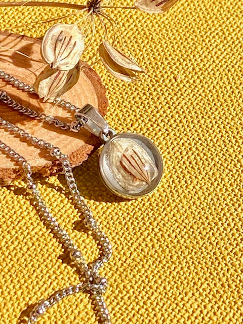 Nature pendant with beige/brown seed of a Hogweed.