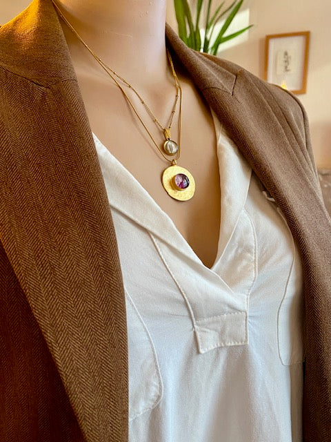 Beige seed with striped pattern in pendant